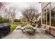 Outdoor patio with dining set near a yard and a house with a view of mature trees at 11691 Diamond Pointe Ct, Indianapolis, IN 46236