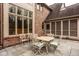 Covered patio with stone pavers, dining set and view of the home's architecture at 11691 Diamond Pointe Ct, Indianapolis, IN 46236