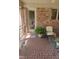 Enclosed brick porch featuring neutral outdoor furniture, brick floors, and a fern at 11691 Diamond Pointe Ct, Indianapolis, IN 46236