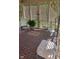 Screened-in porch area with tile floors, fern in pot, and seating with floral patterns at 11691 Diamond Pointe Ct, Indianapolis, IN 46236