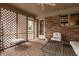 Sunroom with brick floor and brick walls, lattice screens, and ample seating area at 11691 Diamond Pointe Ct, Indianapolis, IN 46236