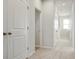 Carpeted hallway featuring white doors, recessed lighting and neutral walls, creating a clean, bright look at 12015 Jeff Ct, Noblesville, IN 46060