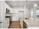 Modern kitchen features stainless steel appliances, an island, and subway tile backsplash at 12015 Jeff Ct, Noblesville, IN 46060