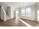 Bright living room with hardwood floors, natural light, and staircase near front door at 12015 Jeff Ct, Noblesville, IN 46060