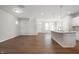 Spacious, light-filled living area with kitchen island, hardwood floors, and stairs at 12015 Jeff Ct, Noblesville, IN 46060