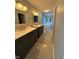 Bathroom features a granite double sink, dark wood cabinets, and a jacuzzi tub in the background at 1258 Soaring Eagle Dr, Greenwood, IN 46143