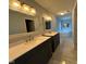 Bathroom features a granite double sink, dark wood cabinets, and a jacuzzi tub in the background at 1258 Soaring Eagle Dr, Greenwood, IN 46143
