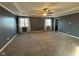 Spacious main bedroom with tray ceiling, ceiling fan, carpet, and lots of natural light at 1258 Soaring Eagle Dr, Greenwood, IN 46143
