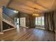 Open concept foyer with a staircase and luxury vinyl plank flooring, featuring modern lighting and gray wall paint at 1258 Soaring Eagle Dr, Greenwood, IN 46143