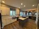 Bright, spacious kitchen with a large island, modern appliances, white cabinets and wood floors at 1258 Soaring Eagle Dr, Greenwood, IN 46143