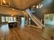 Open-concept living room with staircase, hardwood floors, and expansive windows at 1258 Soaring Eagle Dr, Greenwood, IN 46143