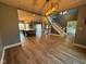 Open-concept view of the kitchen, foyer, living room, and staircase with luxury vinyl plank flooring at 1258 Soaring Eagle Dr, Greenwood, IN 46143