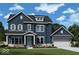 Charming two-story home featuring blue siding, white trim, and a well-manicured lawn at 15810 Vitalize Run, Fishers, IN 46040