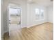 Bright and airy living room with hardwood floors, large windows, and an open doorway at 15810 Vitalize Run, Fishers, IN 46040