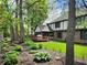 The backyard has a screened porch, deck, and lush landscaping, creating a serene outdoor space at 1728 Timber Heights Dr, Carmel, IN 46280