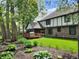 The backyard has a screened porch, deck, and lush landscaping, creating a serene outdoor space at 1728 Timber Heights Dr, Carmel, IN 46280