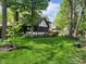 The backyard has a screened porch, deck, and lush landscaping, creating a serene outdoor space at 1728 Timber Heights Dr, Carmel, IN 46280