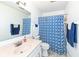 Bathroom featuring a vanity, toilet, and shower with stylish blue patterned curtain and towels at 1728 Timber Heights Dr, Carmel, IN 46280