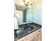 Bathroom features a black marbled countertop and wooden cabinets at 1728 Timber Heights Dr, Carmel, IN 46280