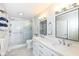 Bright bathroom boasts a glass-enclosed shower, double vanity, and modern fixtures at 1728 Timber Heights Dr, Carmel, IN 46280