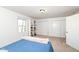 Comfortable carpeted bedroom with a large window and closet storage for ample space at 1728 Timber Heights Dr, Carmel, IN 46280