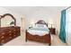 Spacious bedroom featuring an ornate wooden bed frame and dresser with mirror at 1728 Timber Heights Dr, Carmel, IN 46280