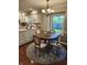 Charming breakfast nook featuring a round wood table, elegant chandelier, and views of the backyard at 1728 Timber Heights Dr, Carmel, IN 46280