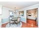 Dining room features a round table, wood floors, and view to the living room at 1728 Timber Heights Dr, Carmel, IN 46280