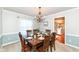 Traditional dining room with wooden furniture, a chandelier, and ample natural light at 1728 Timber Heights Dr, Carmel, IN 46280