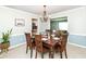 Well-lit dining room with wooden furniture, neutral walls, and an open view of the living space at 1728 Timber Heights Dr, Carmel, IN 46280