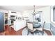 Open concept with dining area featuring wood floors, round table and chandelier at 1728 Timber Heights Dr, Carmel, IN 46280