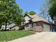 Two-story brick home featuring Tudor accents, attached garage, and well-manicured lawn at 1728 Timber Heights Dr, Carmel, IN 46280