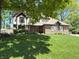 Charming two-story brick home with Tudor accents and a lush green lawn at 1728 Timber Heights Dr, Carmel, IN 46280