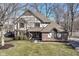 A Tudor-style home with brick and siding, a well-manicured lawn, and a welcoming entrance at 1728 Timber Heights Dr, Carmel, IN 46280