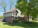 Two-story home featuring Tudor accents, brick facade, green lawn, and mature trees at 1728 Timber Heights Dr, Carmel, IN 46280