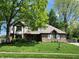 Charming two-story home with brick facade, well-manicured lawn, and mature trees at 1728 Timber Heights Dr, Carmel, IN 46280