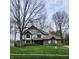 Charming Tudor-style home with brick facade, well-manicured lawn, and mature trees at 1728 Timber Heights Dr, Carmel, IN 46280