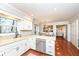 Functional kitchen with white cabinets, stainless steel appliances, and hardwood floors at 1728 Timber Heights Dr, Carmel, IN 46280