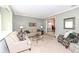 Cozy living room with neutral-toned furniture, carpeted floors, and access to the dining area at 1728 Timber Heights Dr, Carmel, IN 46280