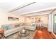 Living room features a large couch, wood floors, and view to dining area at 1728 Timber Heights Dr, Carmel, IN 46280