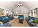 Relaxing sunroom featuring comfortable wicker furniture, a ceiling fan, and outdoor views at 1728 Timber Heights Dr, Carmel, IN 46280