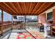 A covered back porch featuring wood floors and view to backyard at 230 N School St, Fortville, IN 46040