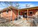 Cozy brick home with a covered back porch featuring a wood deck and a small, fenced yard at 230 N School St, Fortville, IN 46040