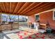 A covered porch with wood floors, backyard view, and wood ceiling at 230 N School St, Fortville, IN 46040