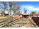 Brick house with a covered back porch surrounded by a large yard with mature trees at 230 N School St, Fortville, IN 46040