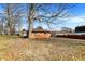 Brick home featuring a spacious backyard with mature trees and a covered porch at 230 N School St, Fortville, IN 46040
