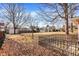 Spacious, fenced backyard with mature trees offering shade and privacy in a residential setting at 230 N School St, Fortville, IN 46040