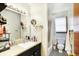 Bathroom with a sink, mirror with vanity lights, and a walk-in shower at 230 N School St, Fortville, IN 46040