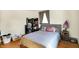Bedroom with hardwood floors, natural light, and a gray upholstered headboard at 230 N School St, Fortville, IN 46040