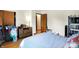 Bedroom featuring hardwood floors, a window, and a wood dresser with drawers at 230 N School St, Fortville, IN 46040